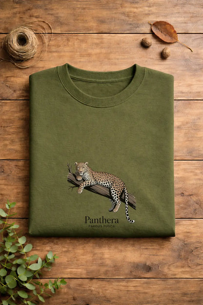 Green t-shirt with a panther design on a wooden surface