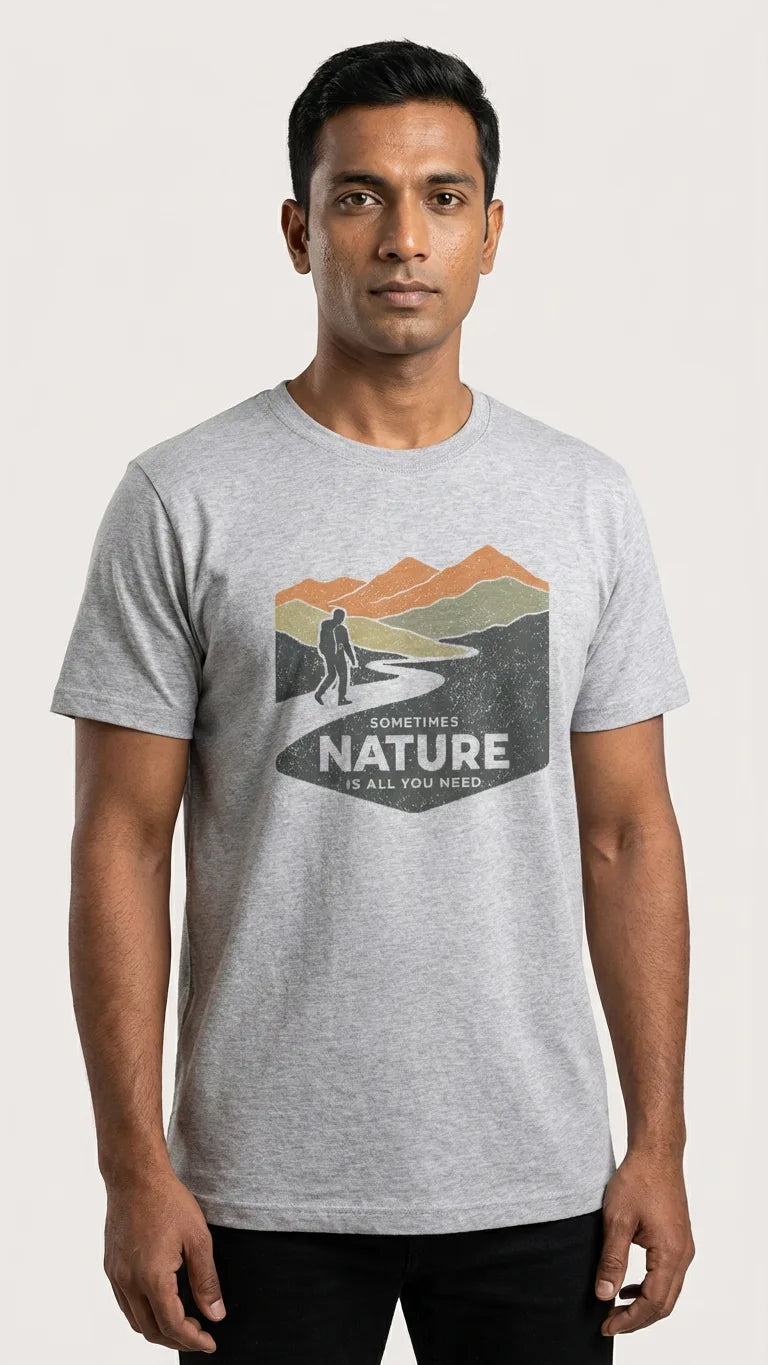 Man wearing a gray t-shirt with a nature graphic and text on a white background