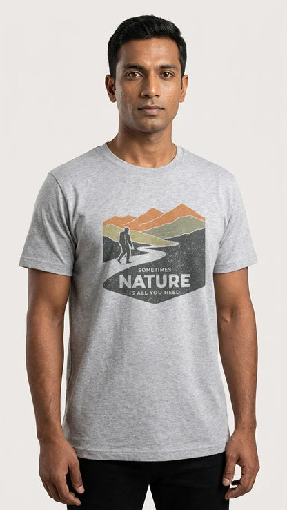Man wearing a gray t-shirt with a nature graphic and text on a white background